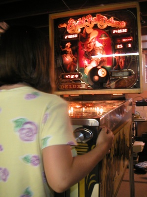 Alyssa playing the pinball game from front.