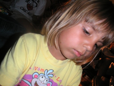 Closeup of Emily during meticulous creation of bead necklace.